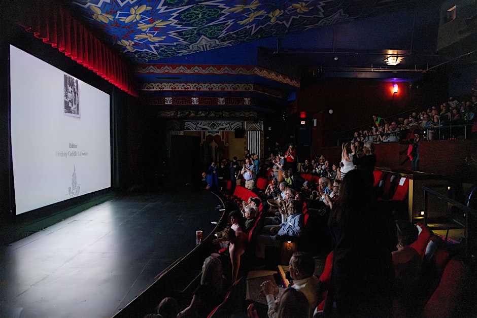 Image of a movie theater full of people watching a screening of WHY ARE YOU YOU?