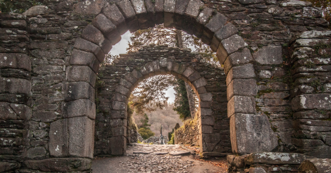 Image of stone arches from a ruined building.